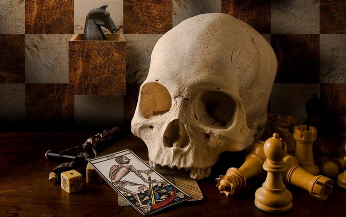 Skull, Tarot Card, Chess Pieces, and Dice on a Table