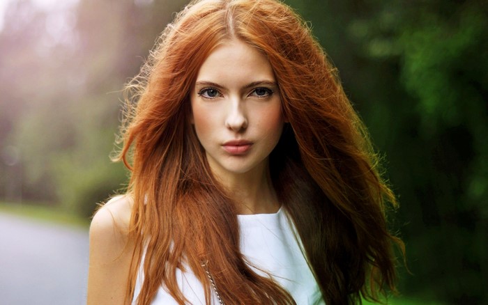 Redhead woman with long hair and blue eyes