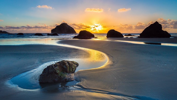 Sunset over rocky beach with tide pools