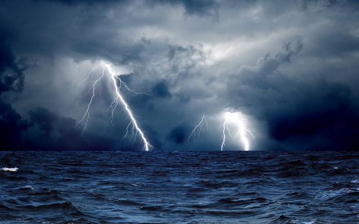 Lightning strikes over a stormy sea