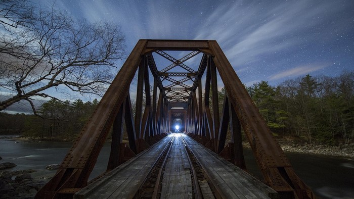Nighttime Railway Bridge with Starry Sky