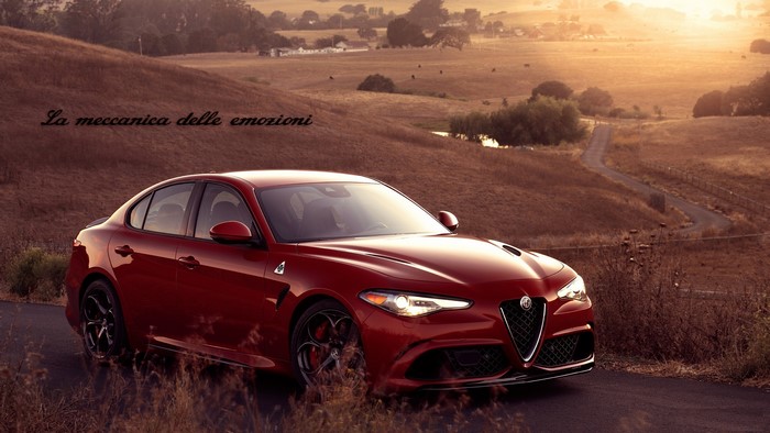 Red Alfa Romeo Giulia on a country road at sunset