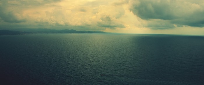 Wide shot of the sea under cloudy sky