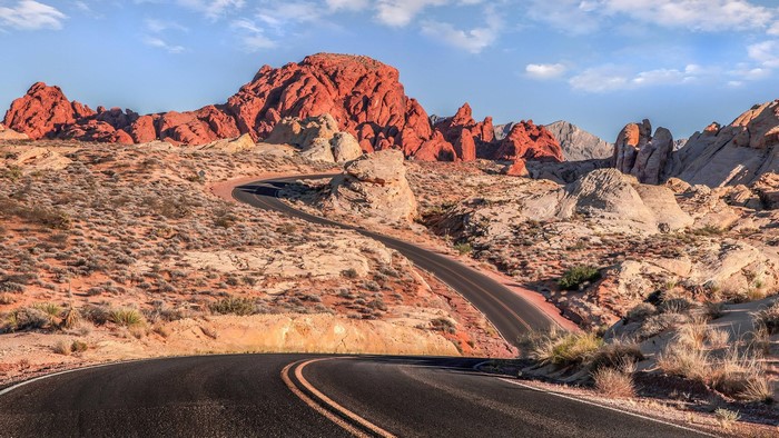 Scenic desert road winding through red rock formations
