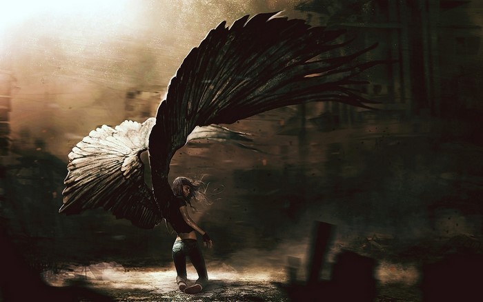 Woman with large black and white angel wings