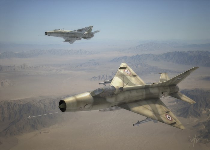Two MiG-21 fighter jets flying over a desert landscape