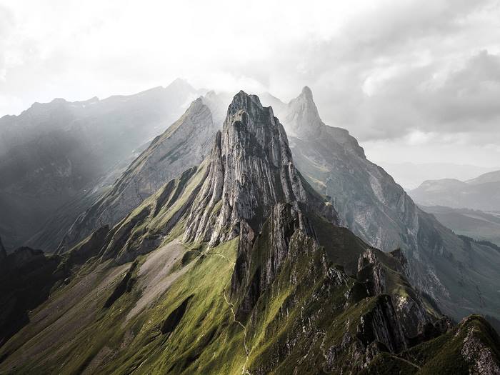 Dramatic mountain peaks in the Swiss Alps under cloudy skies
