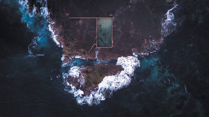 Aerial view of ocean pool on rocky coastline