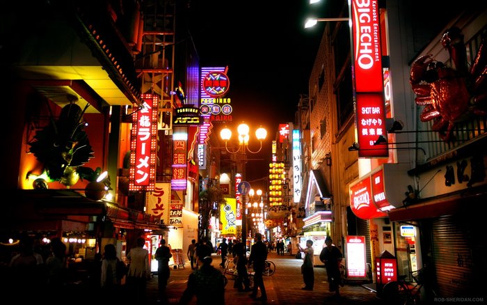 Dotonbori street with neon signs and people at night