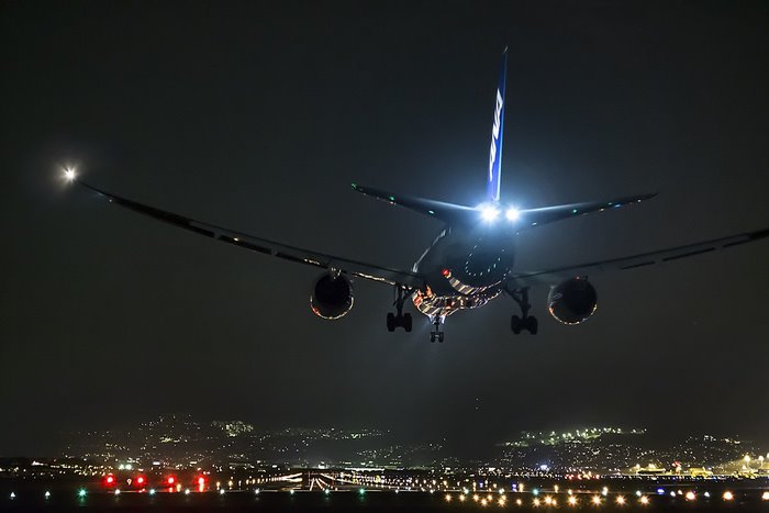 Boeing 777 landing at night airport