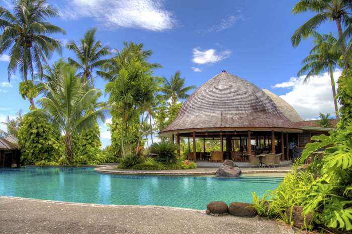 Tropical resort with swimming pool and palm trees