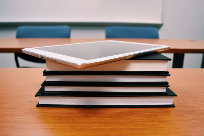 Tablet on a stack of books in a classroom