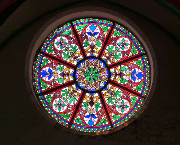Circular stained glass window with floral pattern