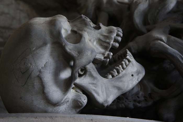 Close-up of a stone skull with open jaw