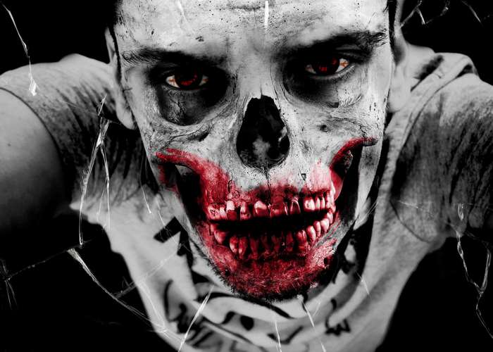 Man with zombie makeup and red eyes