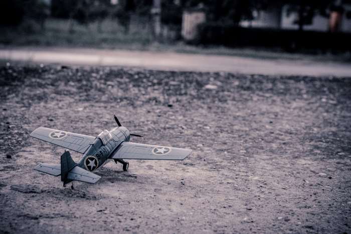 Vintage model airplane on a dirt road