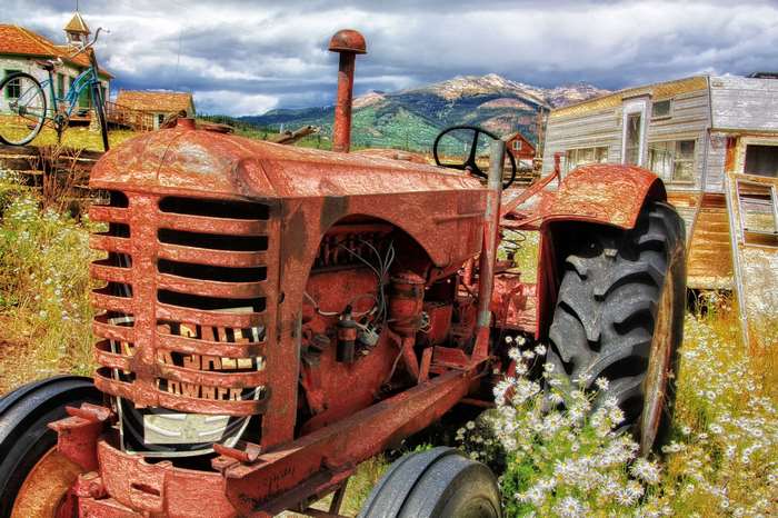 Rusty vintage tractor in a rural landscape