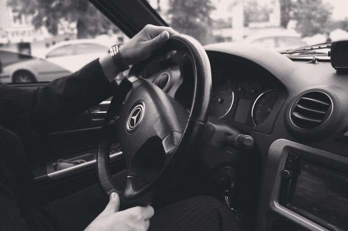 Man driving a Mercedes-Benz car