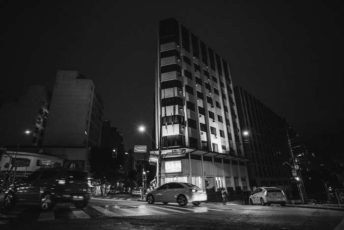 City street at night with buildings and cars