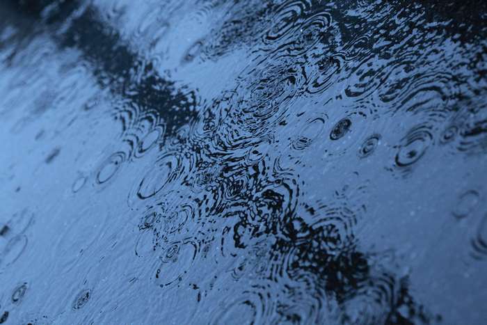 Raindrops on a dark blue surface