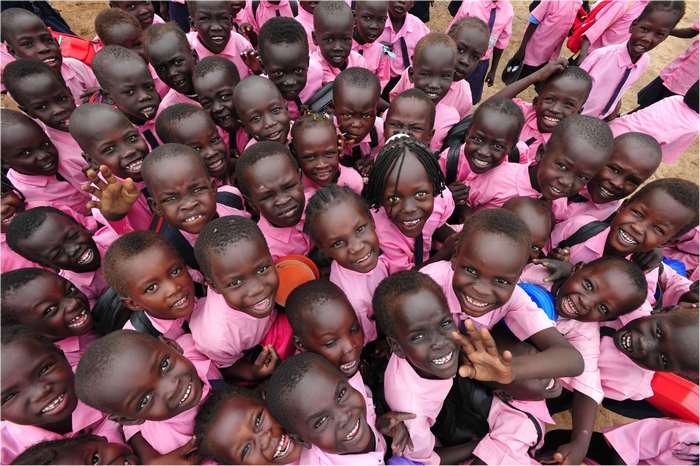 Group of smiling children in pink uniforms