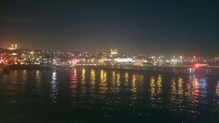 Istanbul at night with city lights and water reflections