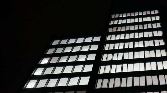 Modern building facade with illuminated windows at night
