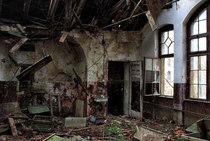 Abandoned building interior with debris and broken windows 4K