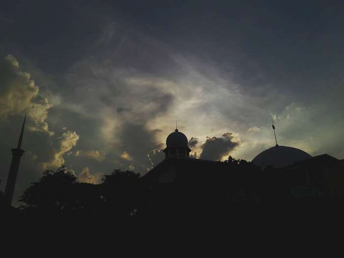 Mosque silhouette against dramatic sky