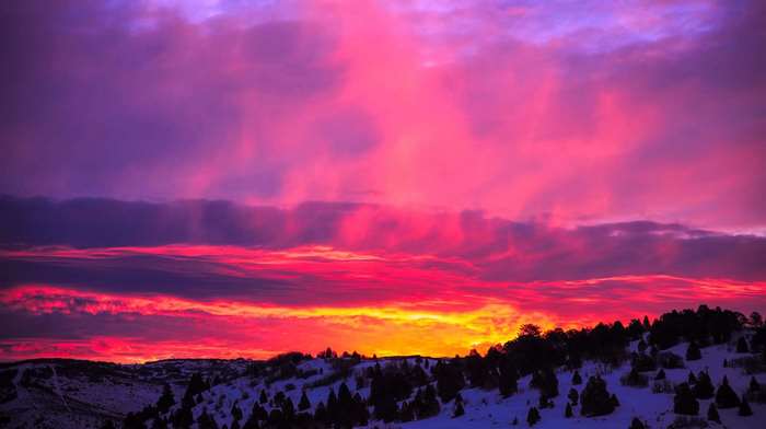 Snowy landscape with colorful sunset sky