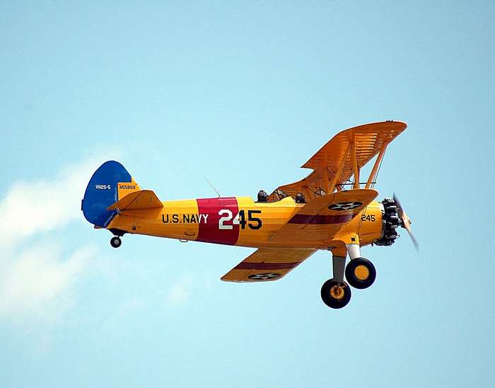 Yellow U.S. Navy Biplane with Number 245 Flying