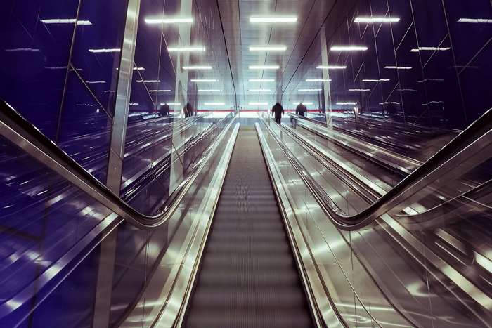 People on escalators in a modern metro station