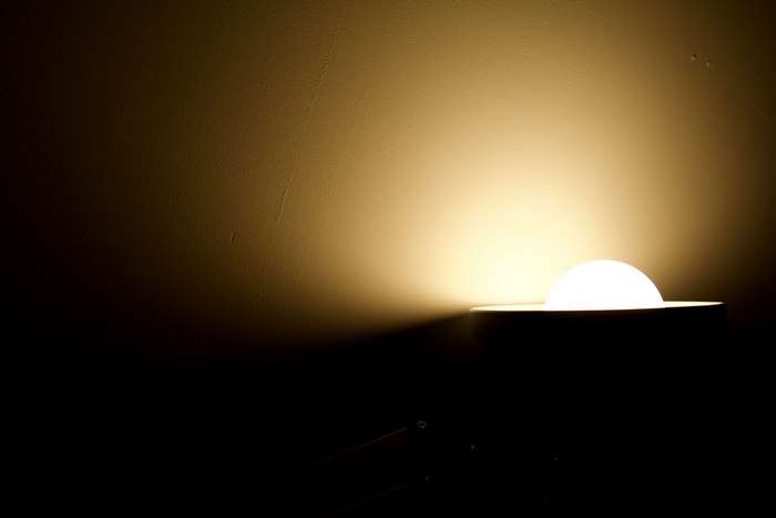 Abstract light bulb illuminating a wall