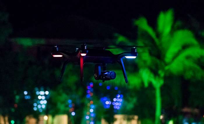 Drone with camera flying at night