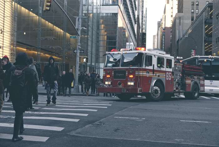 Fire truck and people on zebra crossing in New York City