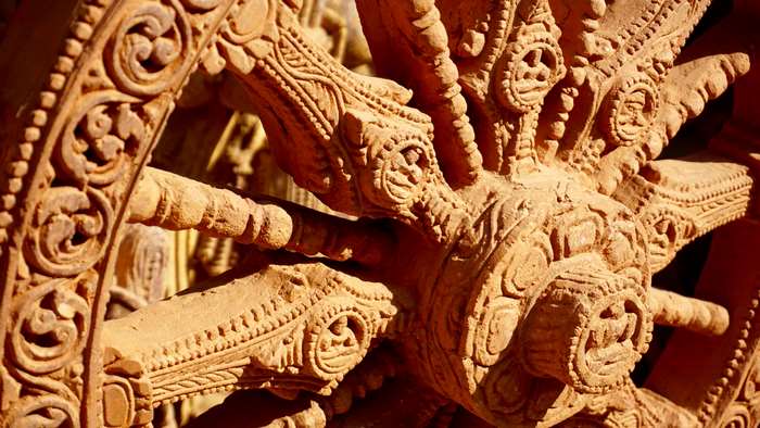 Close-up of an ancient carved stone wheel sculpture
