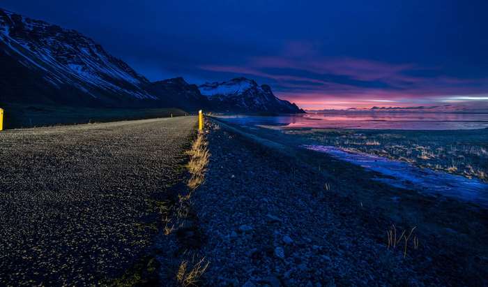 Roadside view of mountains and sea at dusk