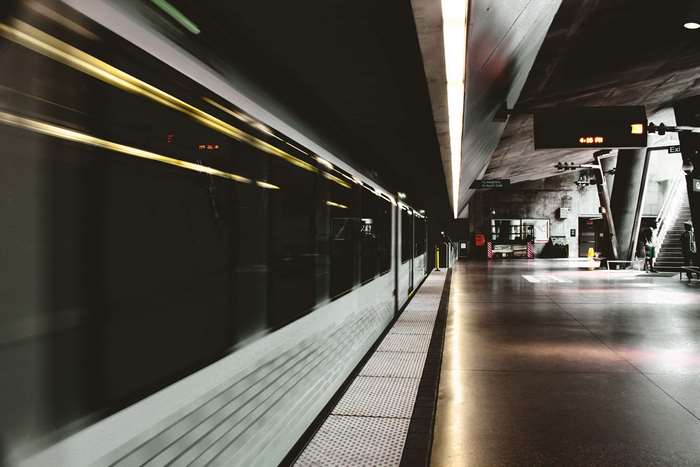Train arriving at a blurred subway station platform