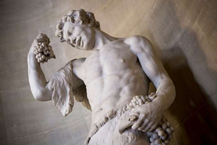 Marble sculpture of a man holding grapes