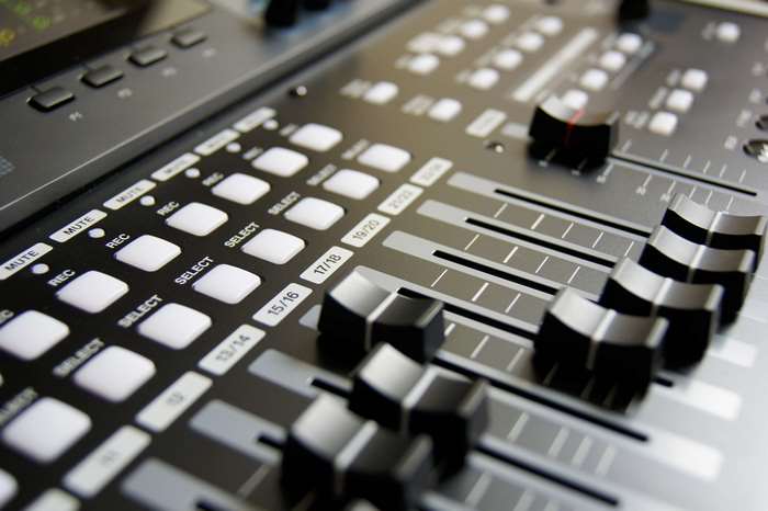 Audio mixer with buttons and faders