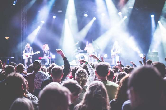 Concert crowd with band performing on stage