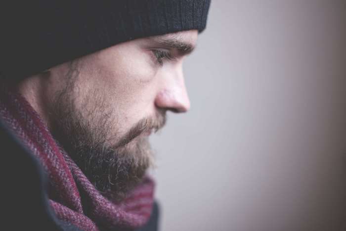 Man with beard wearing a beanie and scarf