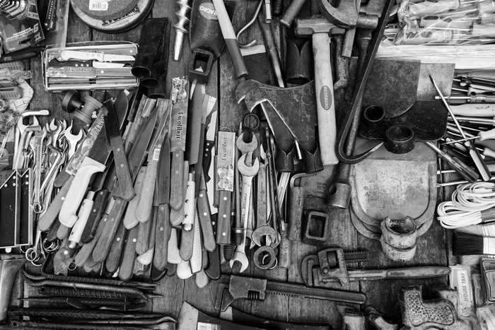 Collection of various tools including knives, wrenches, and axes