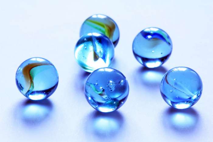 Blue glass marbles with colorful swirls