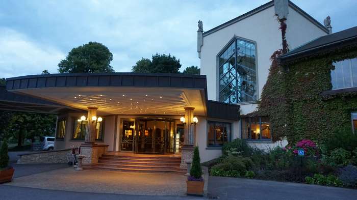 Hotel exterior with entrance and landscaping