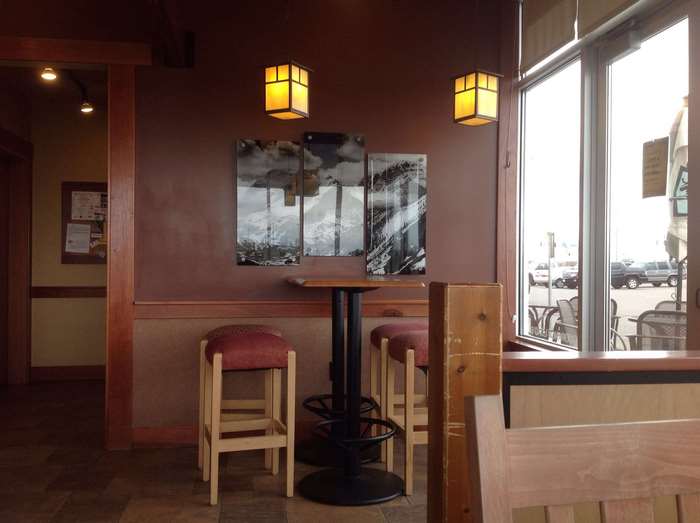 Interior of a coffee shop with bar stools and tables