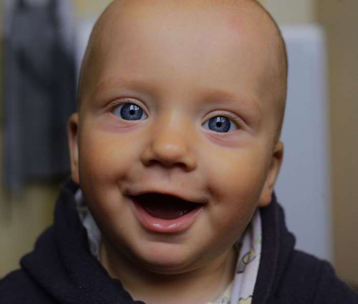 Baby boy with blue eyes smiling