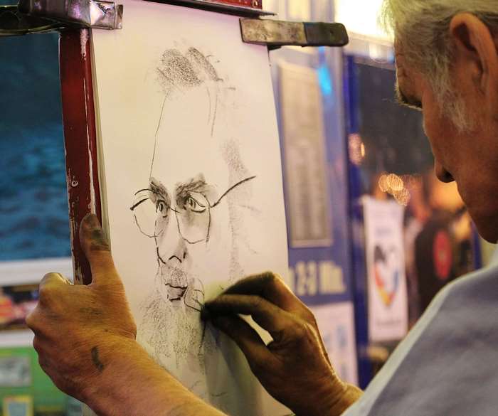 Artist drawing a portrait with charcoal