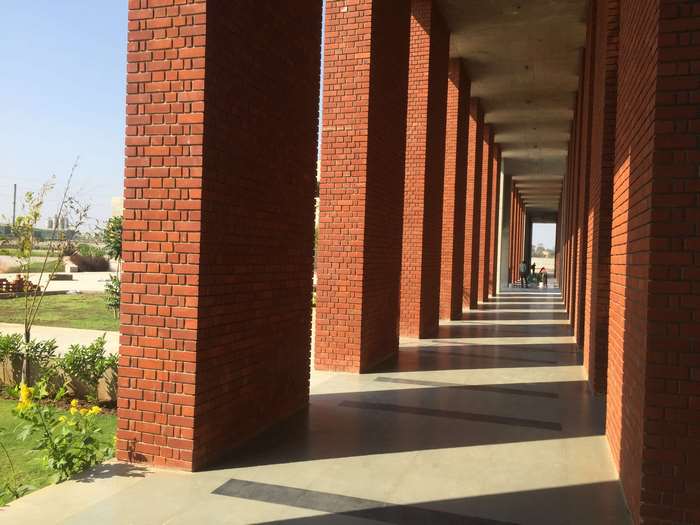Red brick pillars and walkway with sunlight and shadows