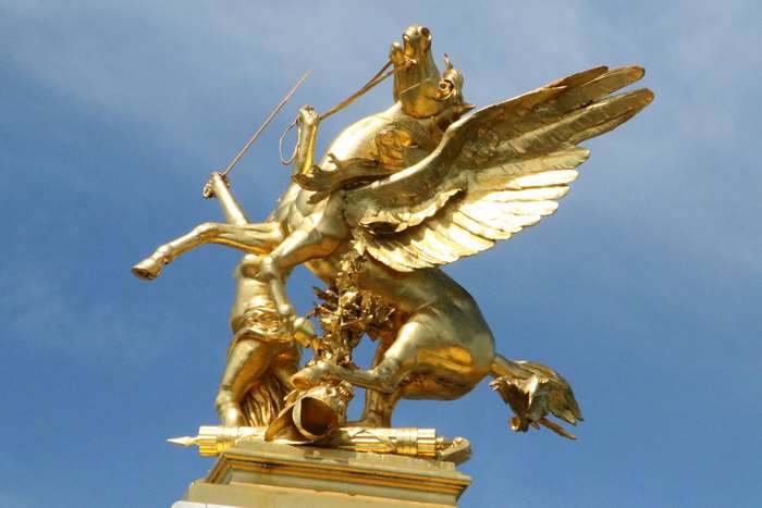 Golden statue of a winged horse and a figure